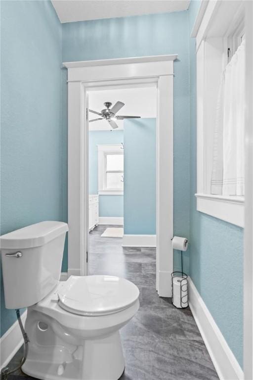 bathroom featuring ceiling fan and toilet