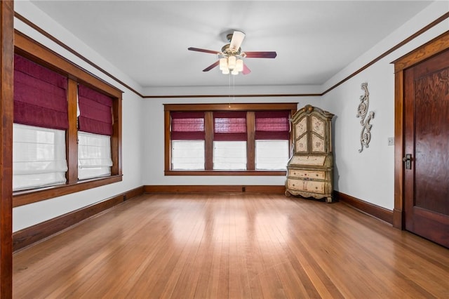 empty room with light hardwood / wood-style flooring and ceiling fan