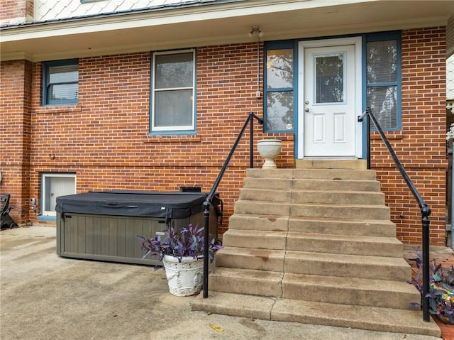 entrance to property with a hot tub