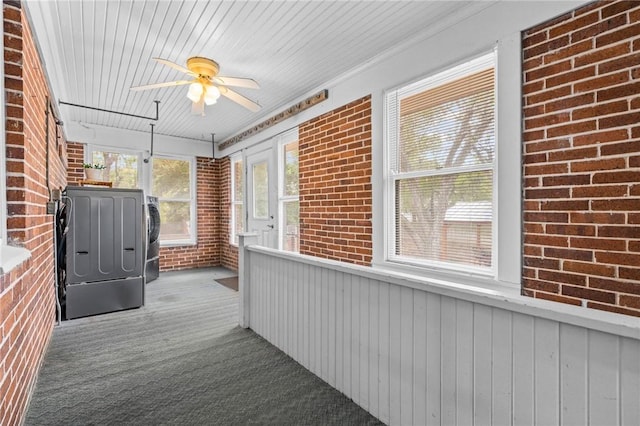 unfurnished sunroom featuring ceiling fan