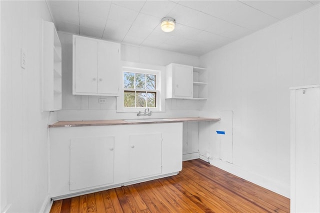 kitchen featuring sink, white cabinets, and light hardwood / wood-style floors