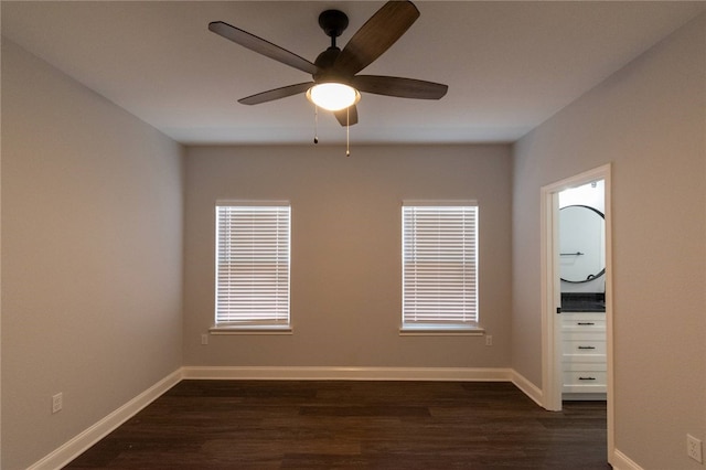 empty room featuring ceiling fan and dark hardwood / wood-style floors