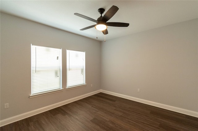 empty room featuring ceiling fan and dark wood-type flooring