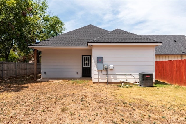 back of property with a yard and cooling unit