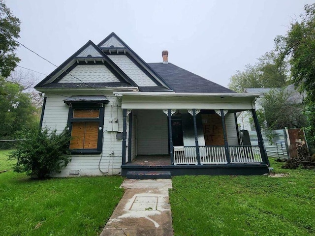 view of front of house with a porch and a front lawn