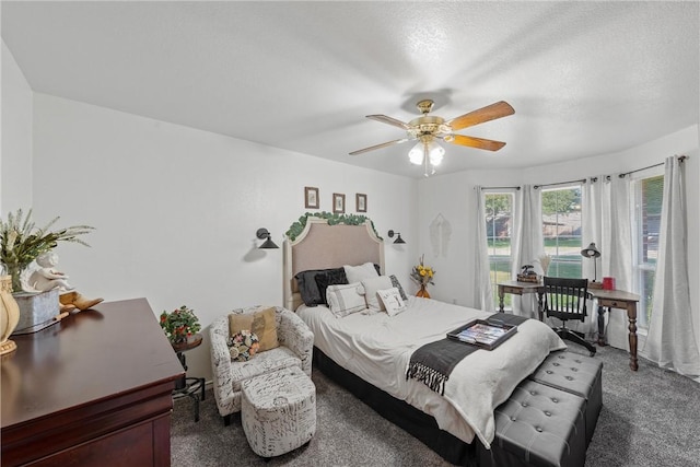 carpeted bedroom featuring a textured ceiling and ceiling fan