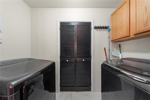 laundry area with cabinets and washing machine and clothes dryer