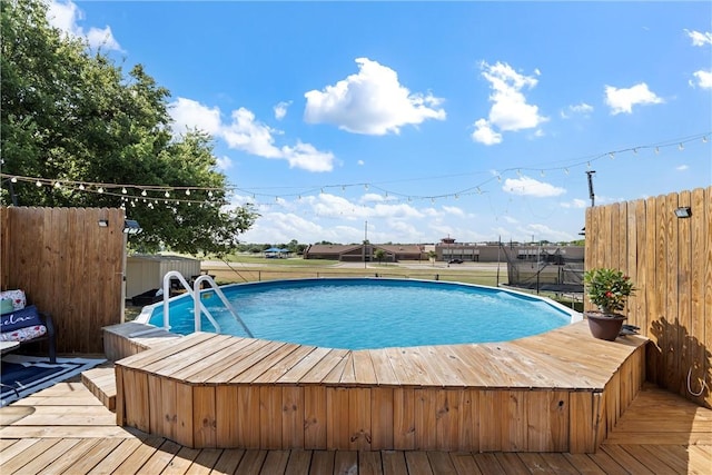 view of swimming pool featuring a wooden deck