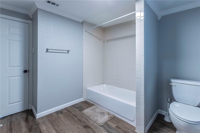 bathroom with toilet, wood-type flooring, crown molding, and bathing tub / shower combination