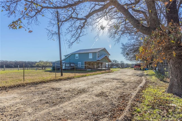 exterior space with a front yard and a rural view