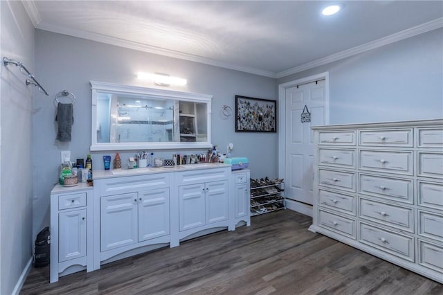 bathroom featuring a shower, vanity, ornamental molding, and hardwood / wood-style flooring