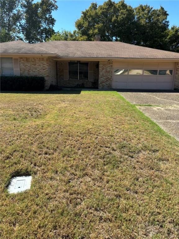 ranch-style home with a garage and a front lawn