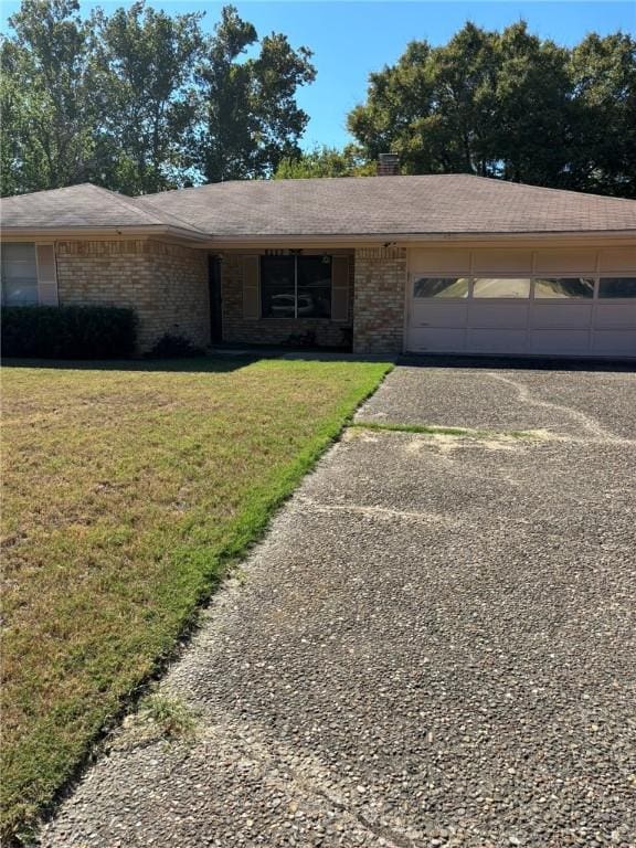 single story home with a garage and a front yard