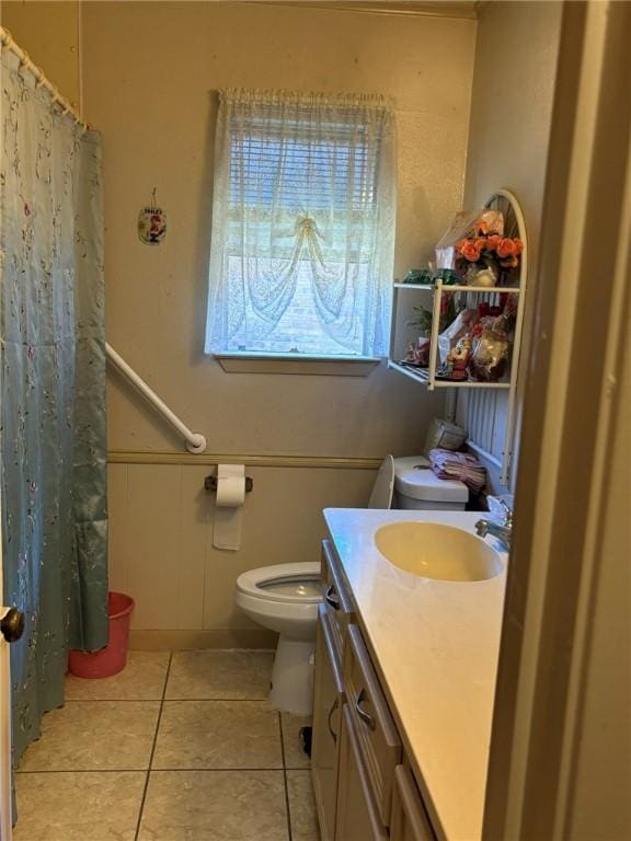 bathroom with vanity, tile patterned floors, toilet, and a shower with shower curtain