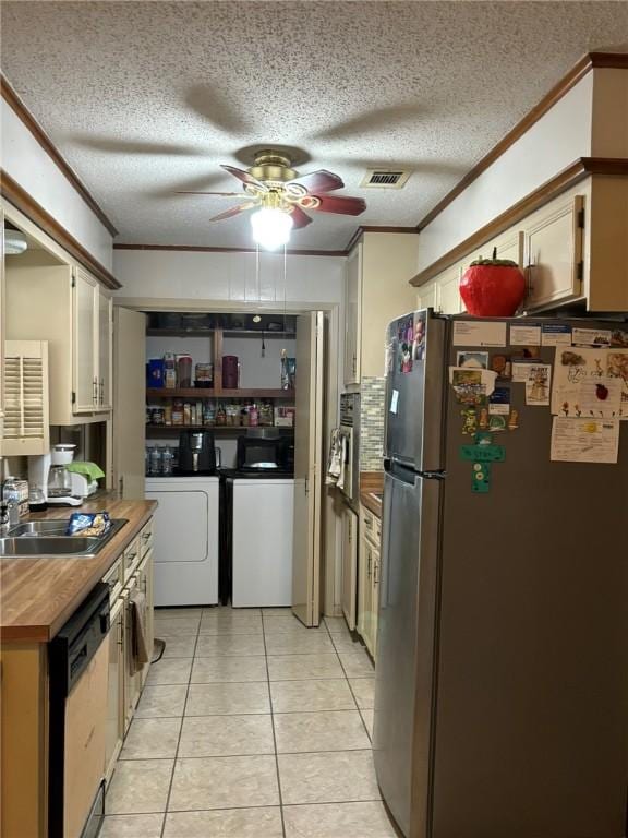 kitchen with stainless steel fridge, white cabinetry, independent washer and dryer, white dishwasher, and ornamental molding