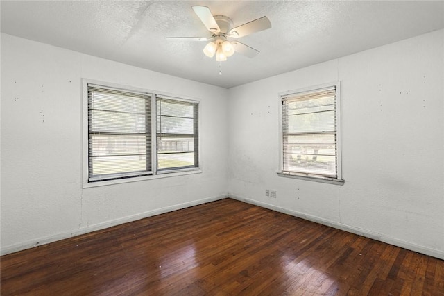 unfurnished room with ceiling fan and dark wood-type flooring