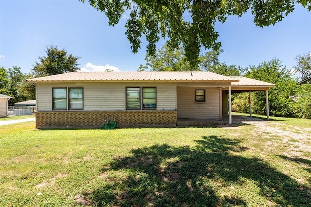 view of front facade with a carport and a front yard