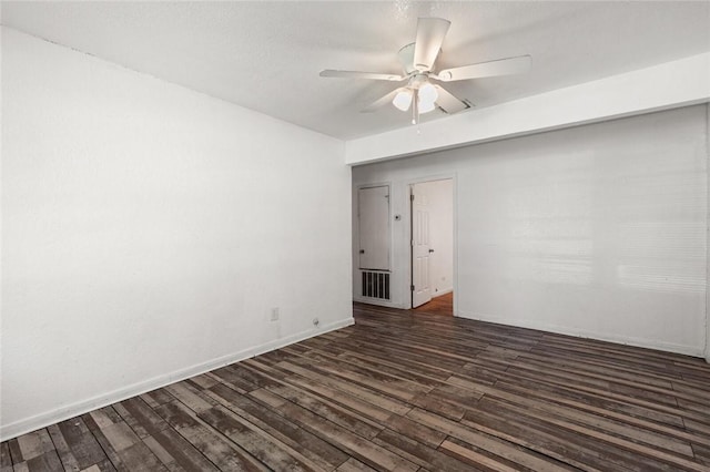 empty room with dark hardwood / wood-style floors and ceiling fan