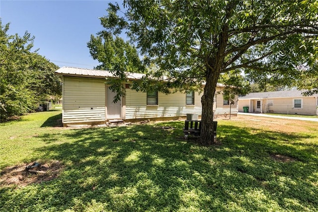 rear view of property with a lawn