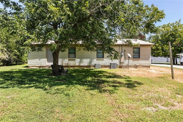 single story home featuring a front yard and central air condition unit