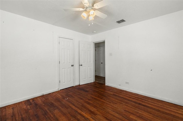 unfurnished bedroom with ceiling fan and dark hardwood / wood-style floors