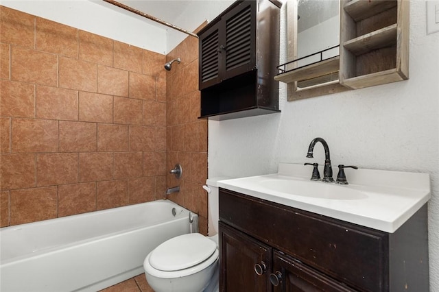 full bathroom featuring tile patterned floors, toilet, vanity, and tiled shower / bath