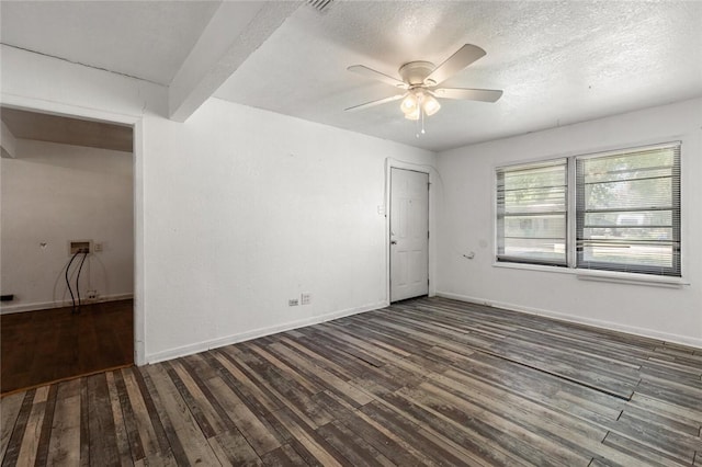 empty room with a textured ceiling, ceiling fan, beam ceiling, and dark wood-type flooring