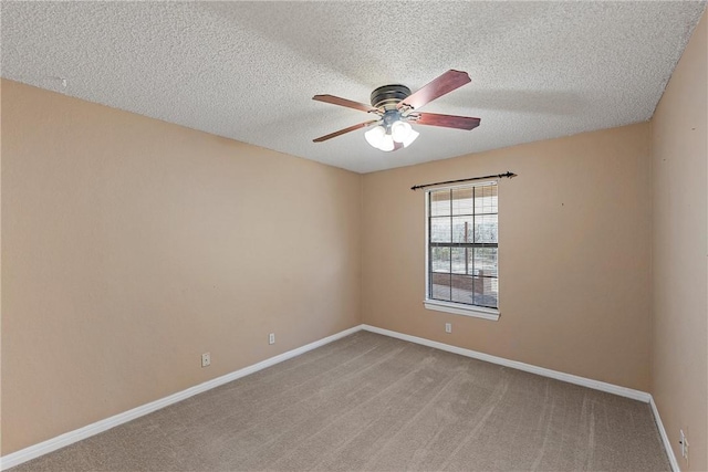 carpeted empty room with ceiling fan and a textured ceiling