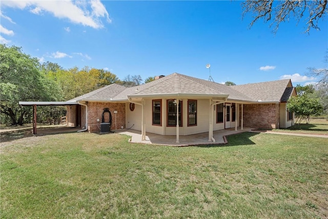 back of house featuring a yard and a carport