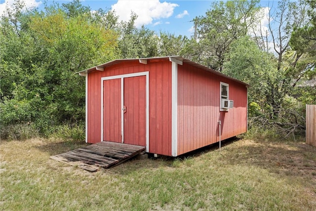 view of outbuilding featuring a yard and cooling unit