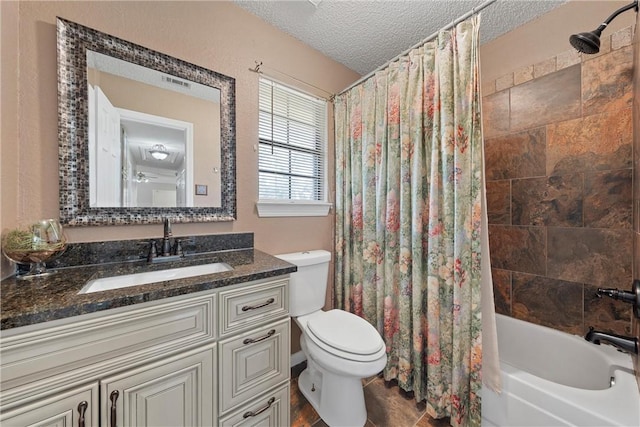 full bathroom featuring shower / tub combo with curtain, vanity, a textured ceiling, and toilet