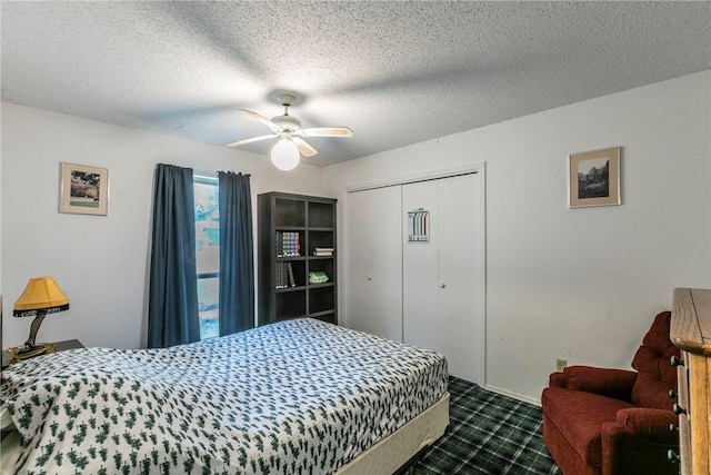 bedroom with dark colored carpet, ceiling fan, a textured ceiling, and a closet