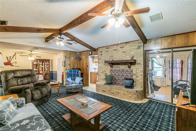 living room with lofted ceiling with beams, a wood stove, a textured ceiling, and wooden walls