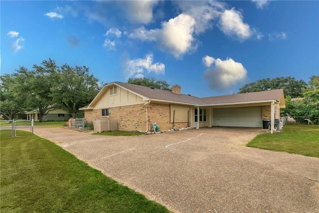 single story home with a front yard and a garage