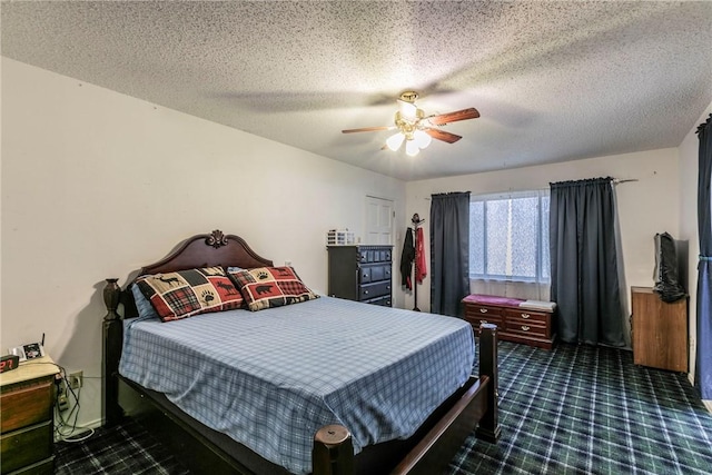 bedroom featuring dark colored carpet, ceiling fan, and a textured ceiling