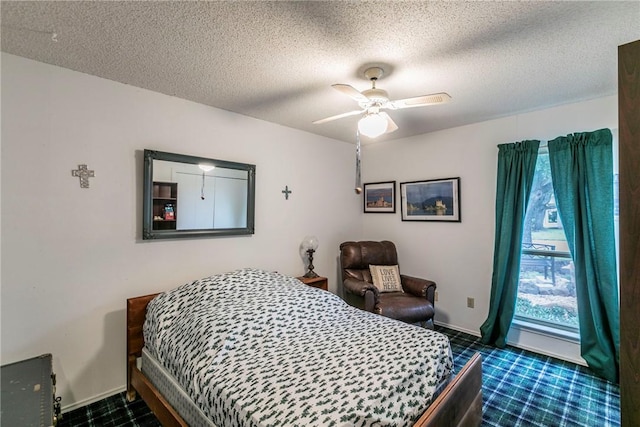 bedroom featuring ceiling fan and a textured ceiling