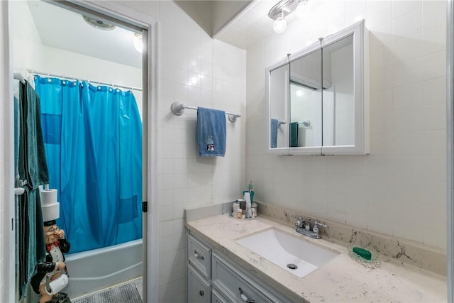 bathroom featuring backsplash, tile walls, vanity, and shower / tub combo