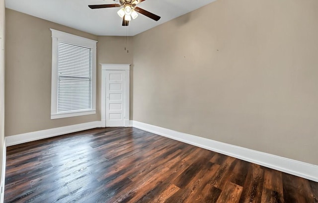 empty room with ceiling fan and dark wood-type flooring