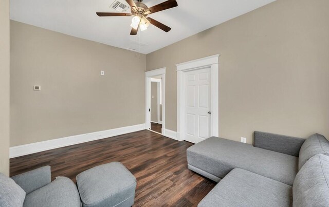 unfurnished room featuring ceiling fan and dark wood-type flooring