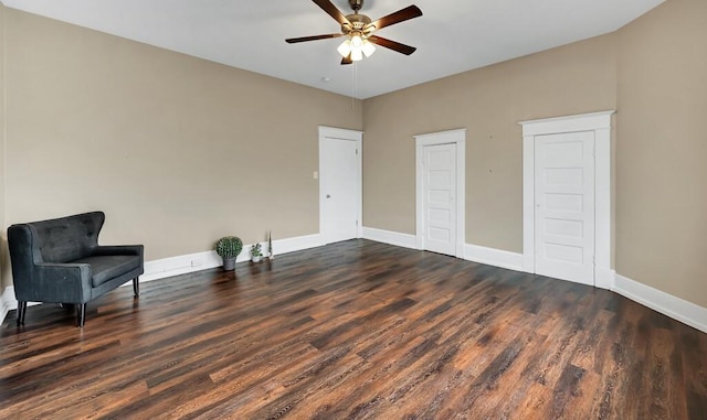 sitting room featuring dark hardwood / wood-style floors and ceiling fan