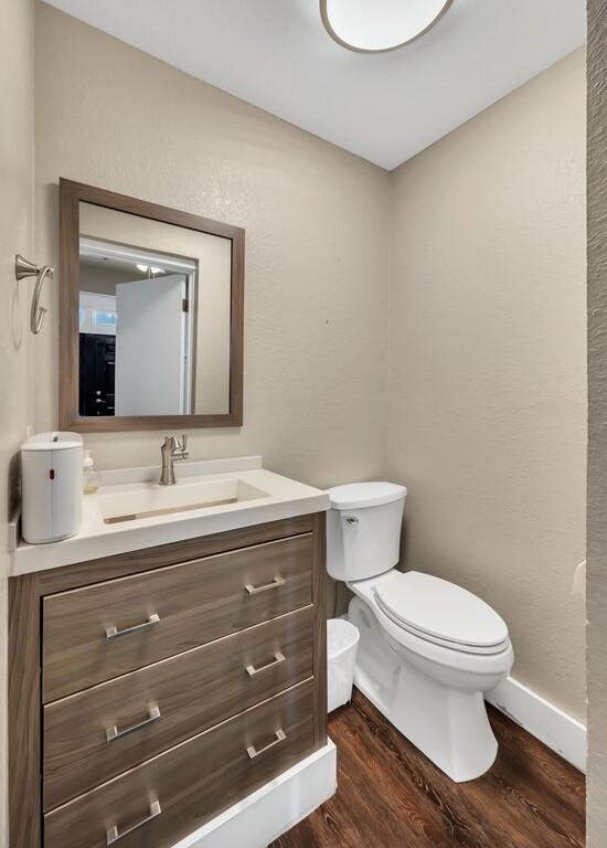 bathroom featuring vanity, toilet, and wood-type flooring