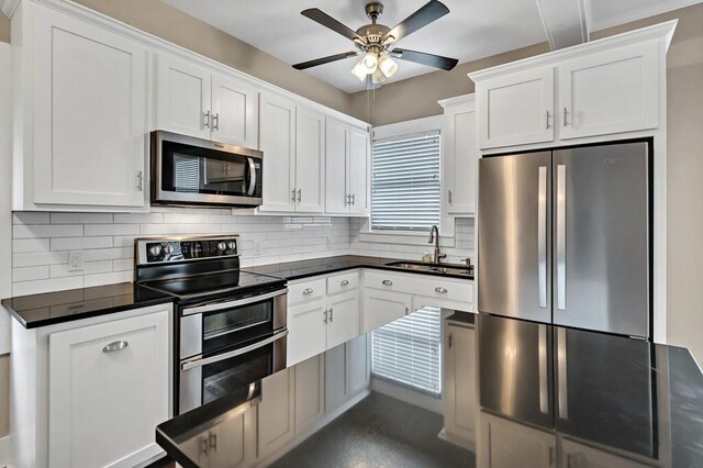 kitchen featuring appliances with stainless steel finishes, dark hardwood / wood-style flooring, tasteful backsplash, and white cabinetry