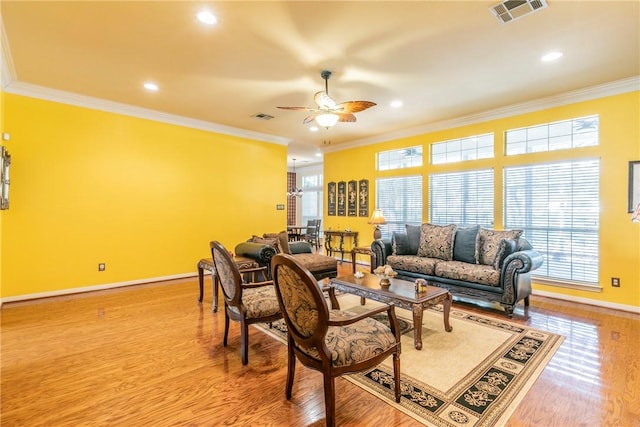 living room with ceiling fan, light hardwood / wood-style flooring, and ornamental molding