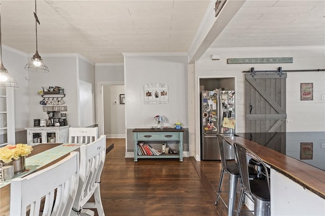 dining area featuring a barn door, dark hardwood / wood-style flooring, and ornamental molding