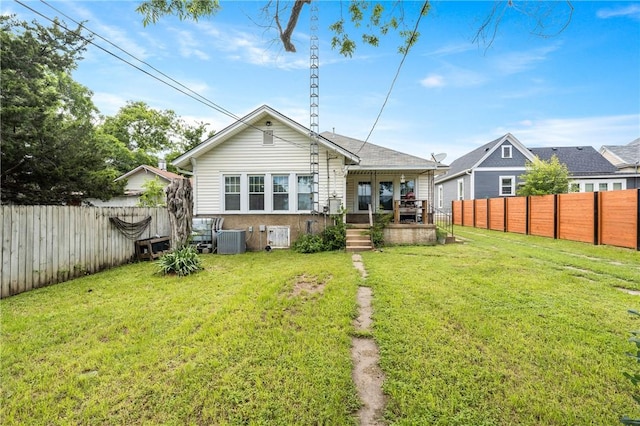 back of property with a lawn and cooling unit