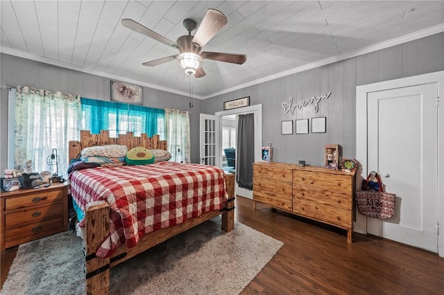 bedroom featuring ceiling fan, wood walls, crown molding, and dark wood-type flooring