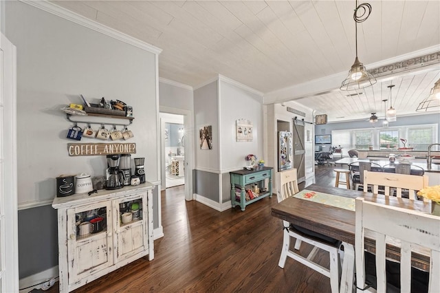 dining room with ornamental molding, wood ceiling, ceiling fan, a barn door, and dark hardwood / wood-style floors