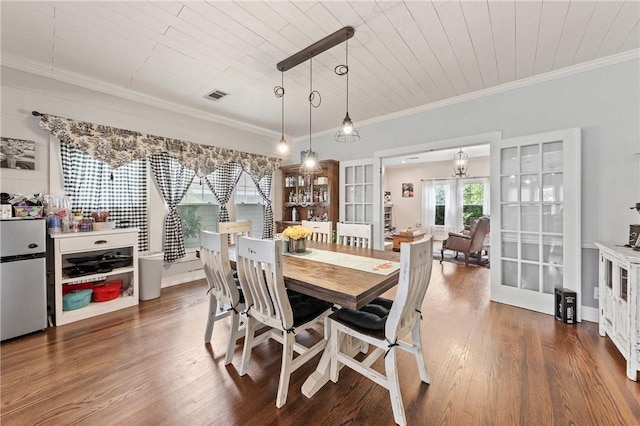 dining space with french doors, dark hardwood / wood-style flooring, ornamental molding, and wooden ceiling