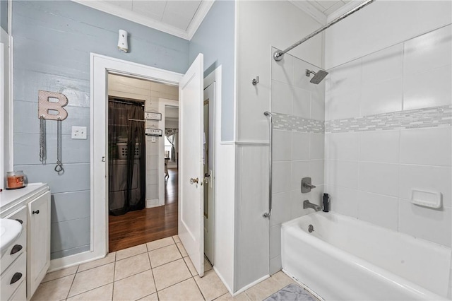 bathroom with tile patterned flooring, vanity, tiled shower / bath combo, and ornamental molding