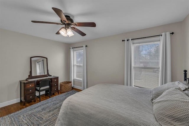 bedroom featuring a ceiling fan, wood finished floors, and baseboards